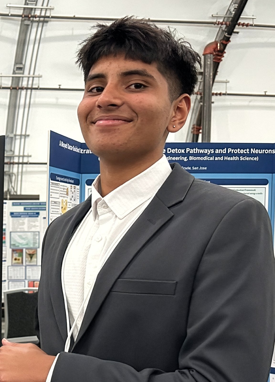 Aarnav Bhat presenting research at a science fair poster session.